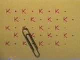 Array of potassium atom symbols - and a paper clip.